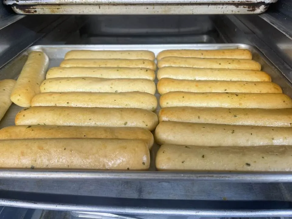 Fresh bread toasting in racks in the oven