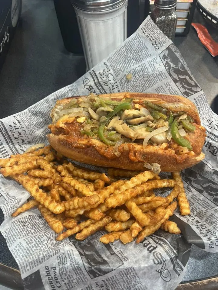 The North Central Cheesesteak loaded with peppers, onions and mushrooms, served with crinkle fries at The Big Dill Grill