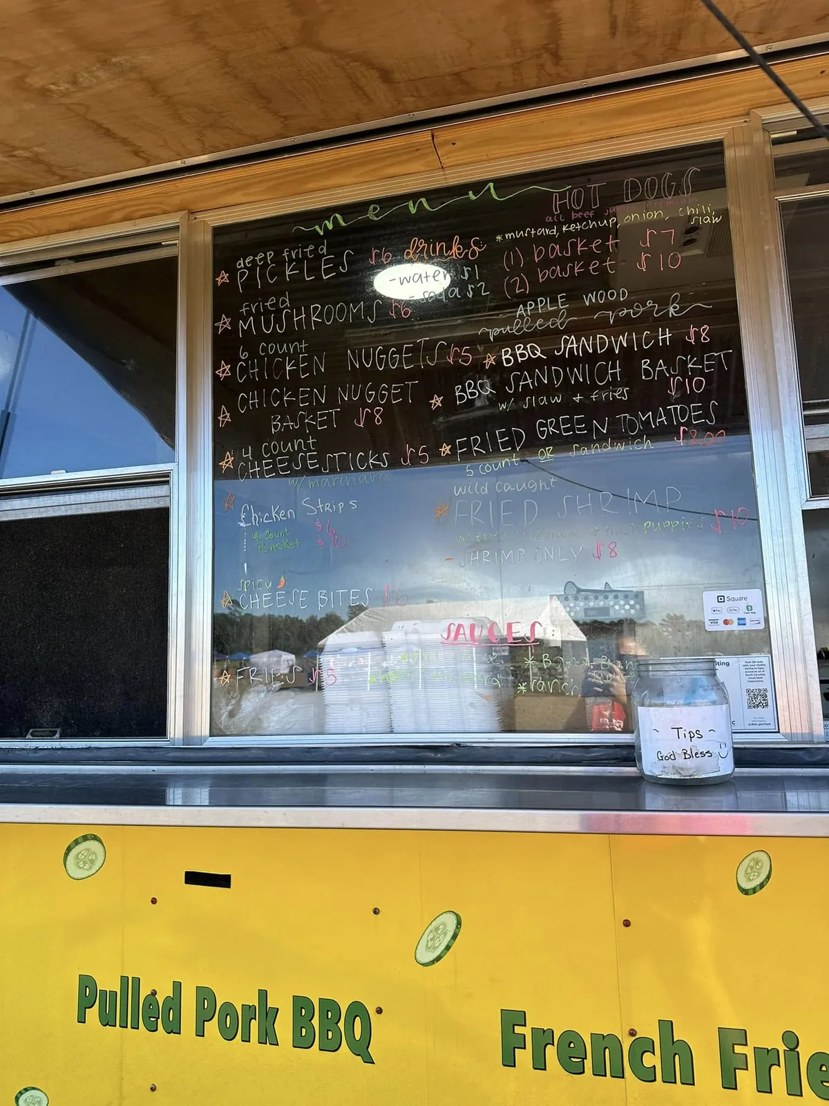 The food truck's chalkboard menu listing fried pickles, BBQ sandwiches, fried shrimp and more